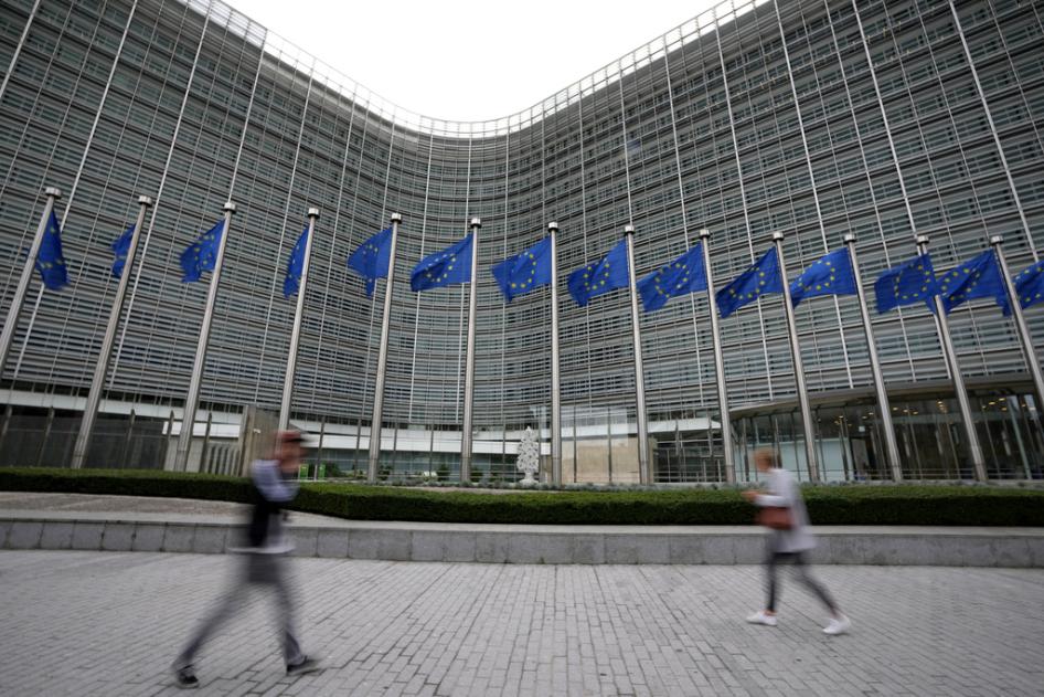 European Union flags wave in the wind as pedestrians walk by EU headquarters in Brussels, Wednesday, Sept. 20, 2023.